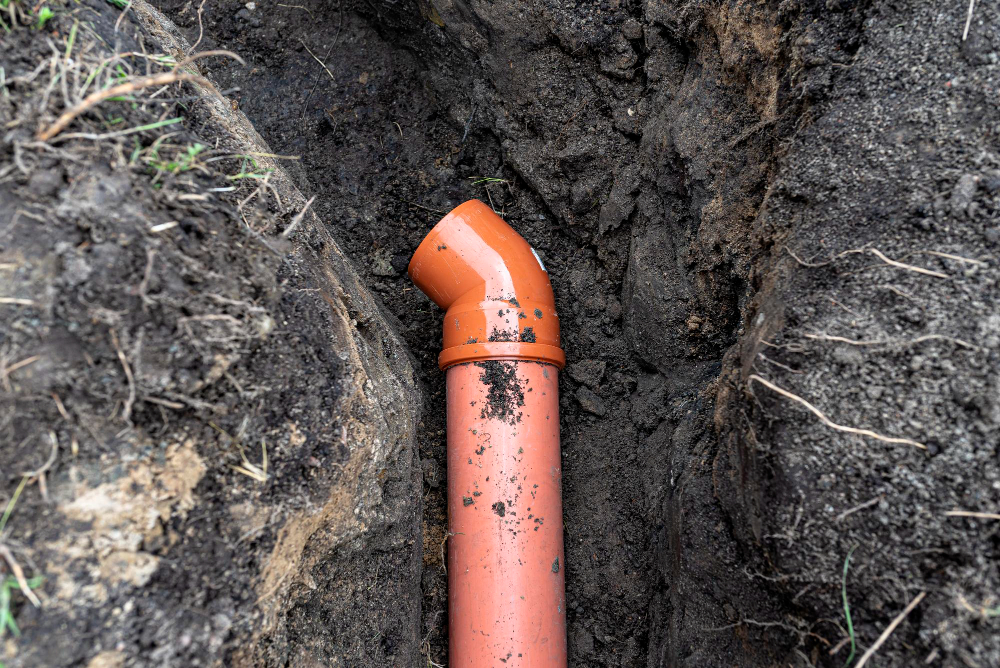 Open trench exposing cracked clay sewer